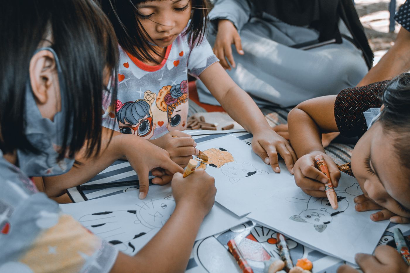 Young children drawing together at daycare.